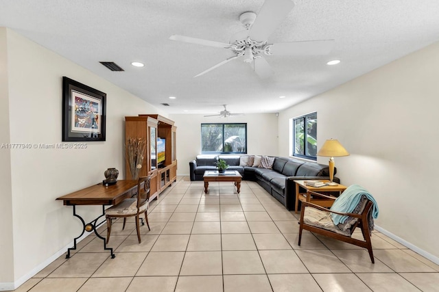 living room featuring visible vents, baseboards, ceiling fan, recessed lighting, and light tile patterned floors