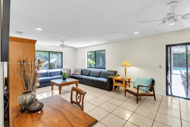 living room featuring visible vents, a ceiling fan, light tile patterned flooring, and recessed lighting