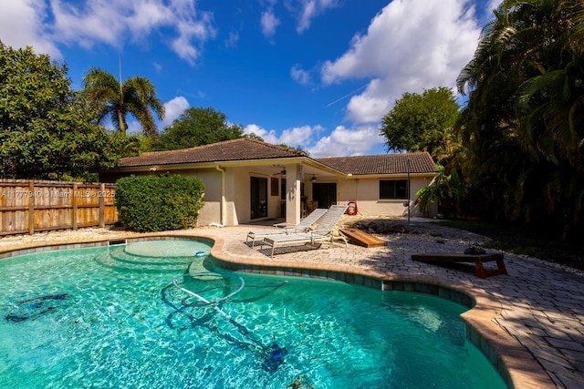 view of swimming pool with ceiling fan, fence, a patio area, and a fenced in pool