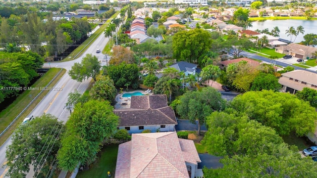 drone / aerial view with a residential view and a water view