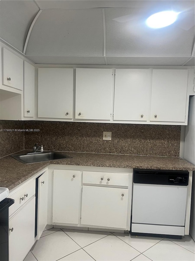 kitchen with light tile patterned floors, stove, white cabinets, dishwasher, and decorative backsplash