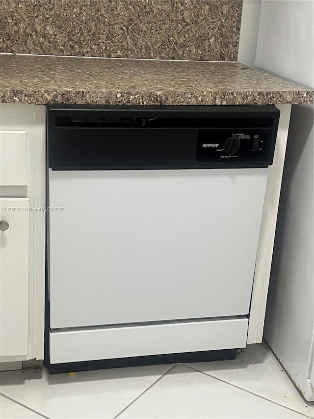 interior details featuring dishwasher and dark countertops