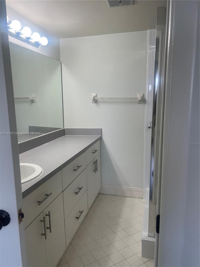 bathroom with vanity and tile patterned flooring
