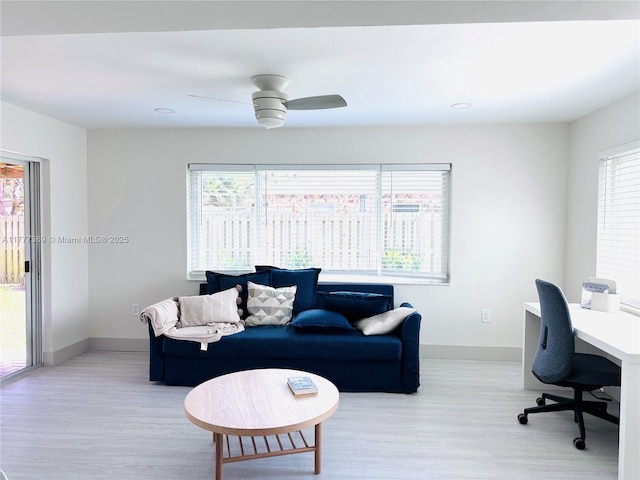 office space with plenty of natural light, baseboards, and light wood-style floors