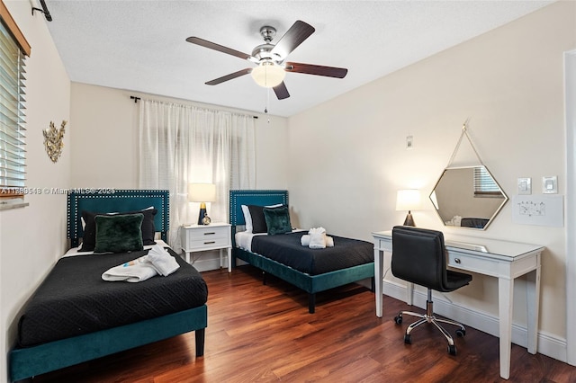 bedroom featuring a ceiling fan, wood finished floors, baseboards, and multiple windows
