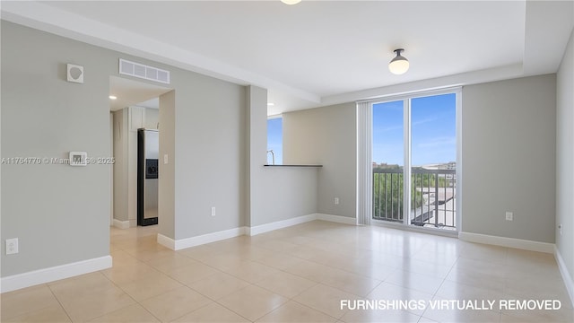 2400 SW 27th Ave Unit 706, Miami, FL 33145 - empty room featuring light tile patterned floors and baseboards