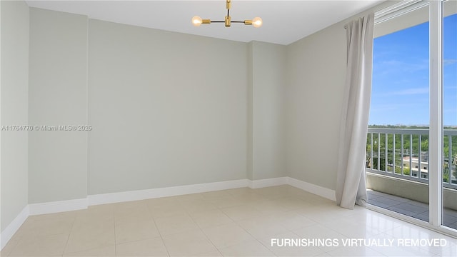 2400 SW 27th Ave Unit 706, Miami, FL 33145 - spare room featuring a chandelier and baseboards