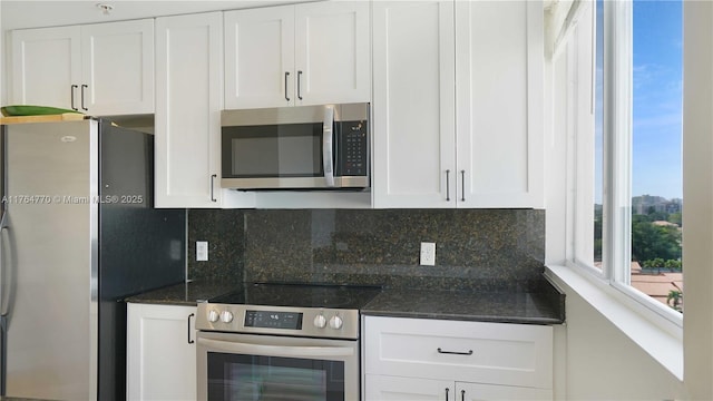 2400 SW 27th Ave Unit 706, Miami, FL 33145 - kitchen with stainless steel appliances, white cabinets, and backsplash