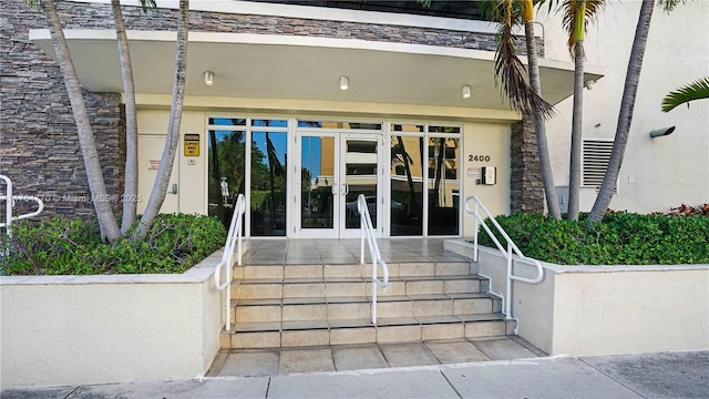 2400 SW 27th Ave Unit 706, Miami, FL 33145 - view of exterior entry with stucco siding and french doors