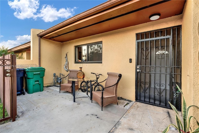 14723 SW 86th Ln, Miami, FL 33193 - view of exterior entry featuring stucco siding and a patio area