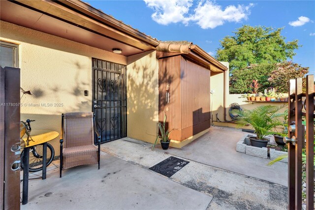 14723 SW 86th Ln, Miami, FL 33193 - property entrance with a patio and stucco siding