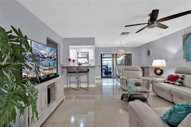 14723 SW 86th Ln, Miami, FL 33193 - living room with a chandelier, ceiling fan, light tile patterned floors, and a textured ceiling