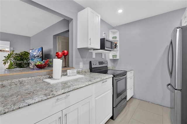 14723 SW 86th Ln, Miami, FL 33193 - kitchen featuring stainless steel appliances, white cabinetry, light tile patterned flooring, light stone counters, and recessed lighting