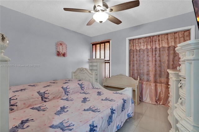 14723 SW 86th Ln, Miami, FL 33193 - bedroom with light tile patterned floors, a textured ceiling, and a ceiling fan