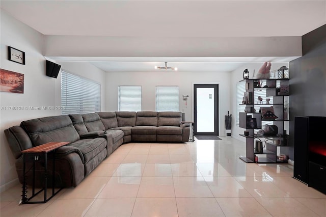 living area featuring light tile patterned floors and baseboards
