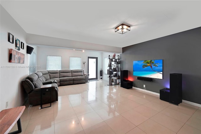 living area featuring light tile patterned floors and baseboards