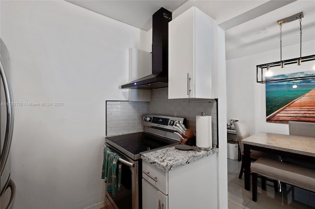 kitchen featuring stainless steel range with electric cooktop, light tile patterned floors, wall chimney range hood, white cabinets, and decorative backsplash