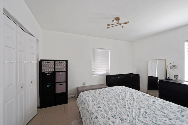 bedroom featuring a closet and light tile patterned floors
