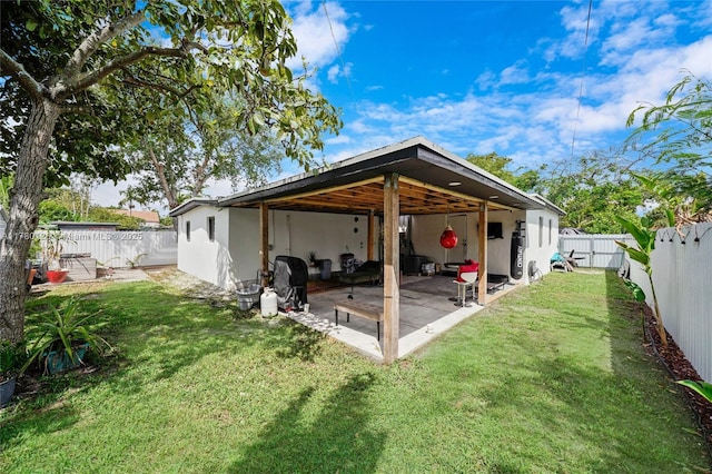 back of property featuring a patio area, a fenced backyard, stucco siding, and a lawn