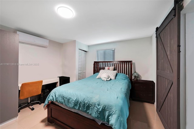 bedroom with a wall mounted AC and a barn door