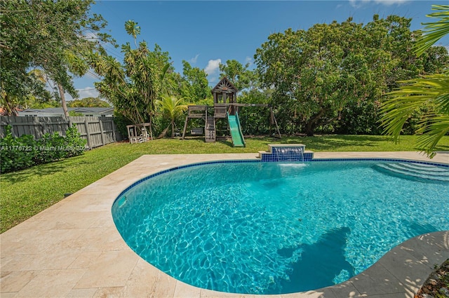 1901 NE 186th Dr, North Miami Beach, FL 33179 - view of swimming pool with fence, a fenced in pool, a yard, and a playground