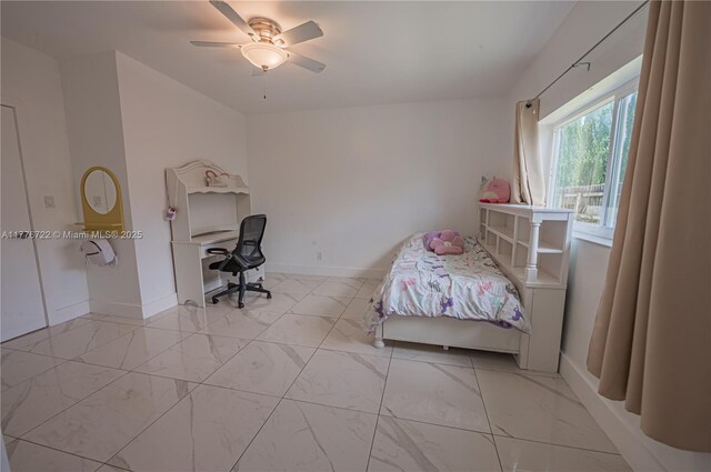 1901 NE 186th Dr, North Miami Beach, FL 33179 - bedroom with baseboards, a ceiling fan, and marble finish floor