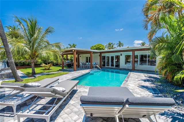 2243 Bayview Ln, North Miami, FL 33181 - outdoor pool featuring french doors and a patio area