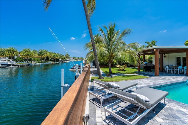 2243 Bayview Ln, North Miami, FL 33181 - dock area with a patio, a water view, and an outdoor pool