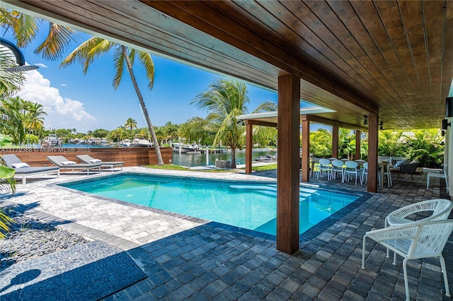 2243 Bayview Ln, North Miami, FL 33181 - pool with a patio, a water view, and fence