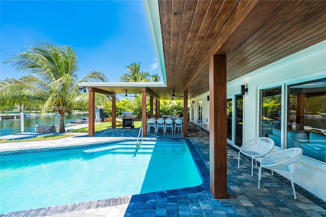 2243 Bayview Ln, North Miami, FL 33181 - pool with a patio, a water view, ceiling fan, and area for grilling