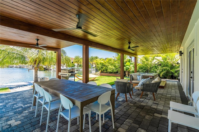 2243 Bayview Ln, North Miami, FL 33181 - view of patio featuring an outdoor living space, a water view, a ceiling fan, and a hot tub