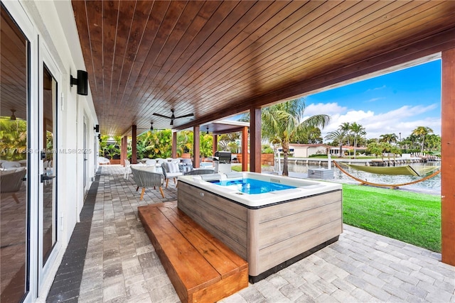 2243 Bayview Ln, North Miami, FL 33181 - view of patio with an outdoor hangout area, a water view, and a hot tub