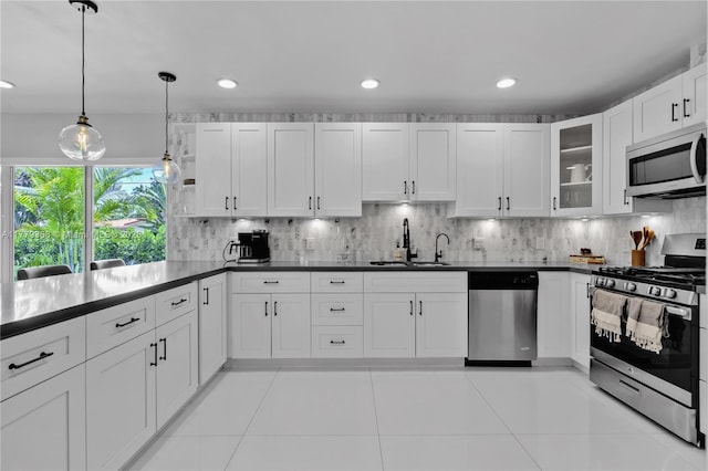 2243 Bayview Ln, North Miami, FL 33181 - kitchen with a sink, decorative backsplash, dark countertops, and stainless steel appliances