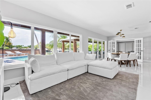 2243 Bayview Ln, North Miami, FL 33181 - living area featuring baseboards, tile patterned floors, visible vents, and french doors