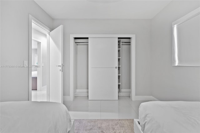 2243 Bayview Ln, North Miami, FL 33181 - tiled bedroom featuring a closet and baseboards