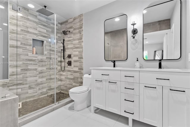 2243 Bayview Ln, North Miami, FL 33181 - bathroom featuring tile patterned flooring, double vanity, toilet, a sink, and a stall shower