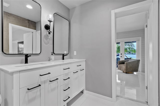 2243 Bayview Ln, North Miami, FL 33181 - bathroom with a sink, baseboards, tile patterned flooring, and double vanity
