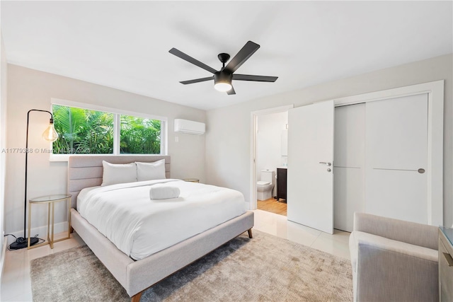 2243 Bayview Ln, North Miami, FL 33181 - bedroom with a closet, ensuite bath, an AC wall unit, a ceiling fan, and light tile patterned floors