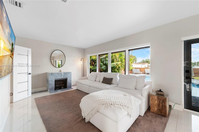 2243 Bayview Ln, North Miami, FL 33181 - living room featuring visible vents, baseboards, tile patterned floors, and a premium fireplace