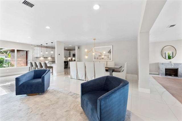 2243 Bayview Ln, North Miami, FL 33181 - living room with visible vents, light tile patterned floors, a chandelier, and a fireplace