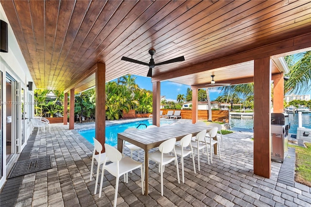 2243 Bayview Ln, North Miami, FL 33181 - view of patio / terrace with a fenced in pool, a water view, ceiling fan, and outdoor dry bar