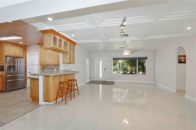 13130 NW 1st Ave, Miami, FL 33168 - kitchen with stainless steel refrigerator with ice dispenser, arched walkways, baseboards, open floor plan, and decorative backsplash