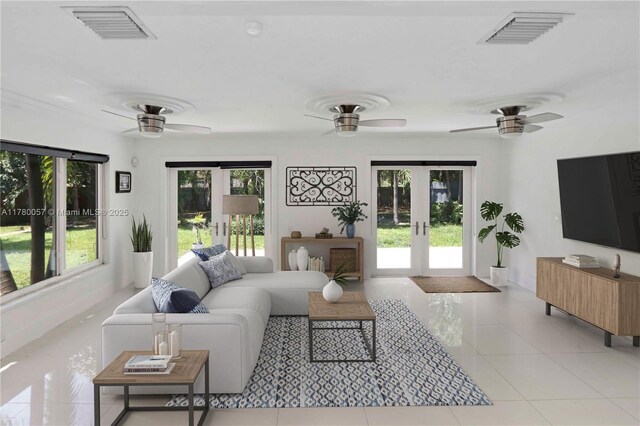 living room with french doors, ceiling fan, and visible vents