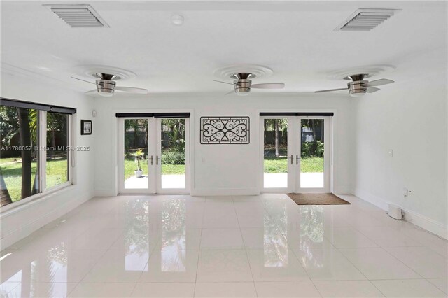 spare room featuring french doors, ceiling fan, visible vents, and light tile patterned floors