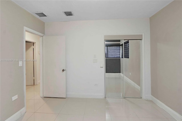 unfurnished bedroom featuring visible vents, baseboards, and tile patterned flooring