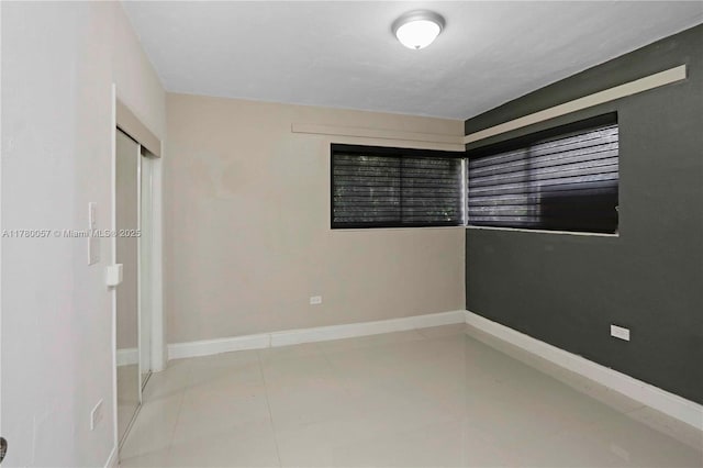 13130 NW 1st Ave, Miami, FL 33168 - tiled empty room featuring baseboards