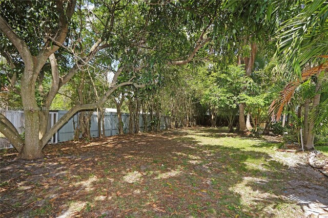 view of yard with a fenced backyard and a gate