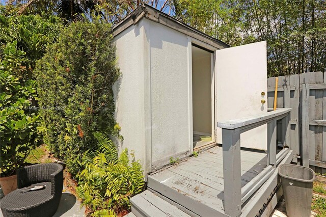 view of outbuilding with fence