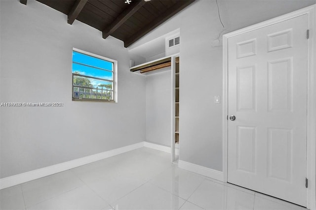 3900 SW 47th Ave, West Park, FL 33023 - unfurnished bedroom featuring baseboards, lofted ceiling with beams, light tile patterned floors, visible vents, and wooden ceiling