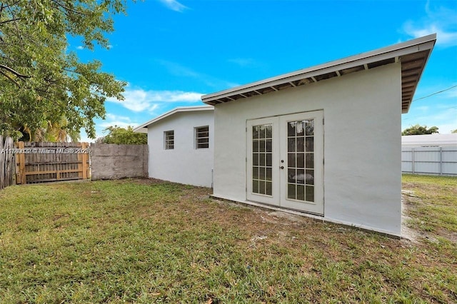 3900 SW 47th Ave, West Park, FL 33023 - rear view of property with french doors, a yard, stucco siding, and fence